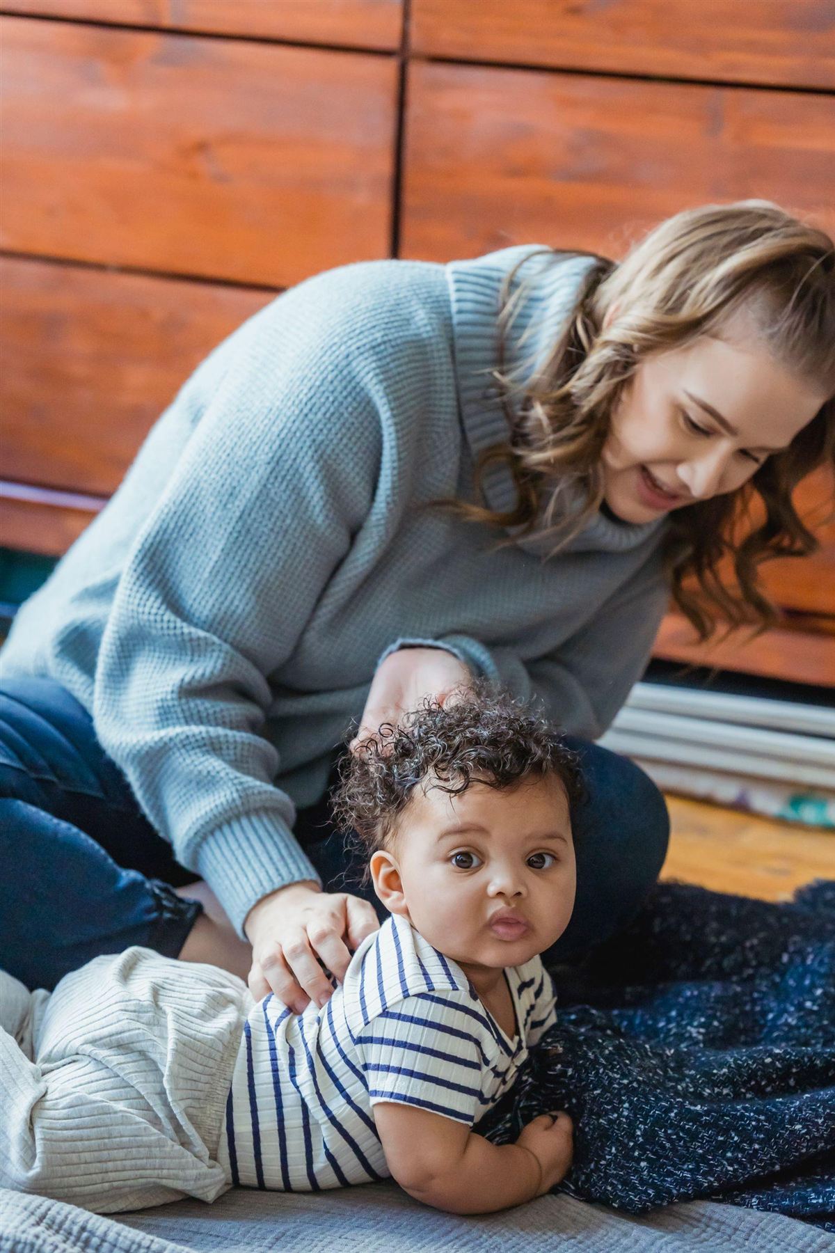 A mother playing on the floor with her toddler
