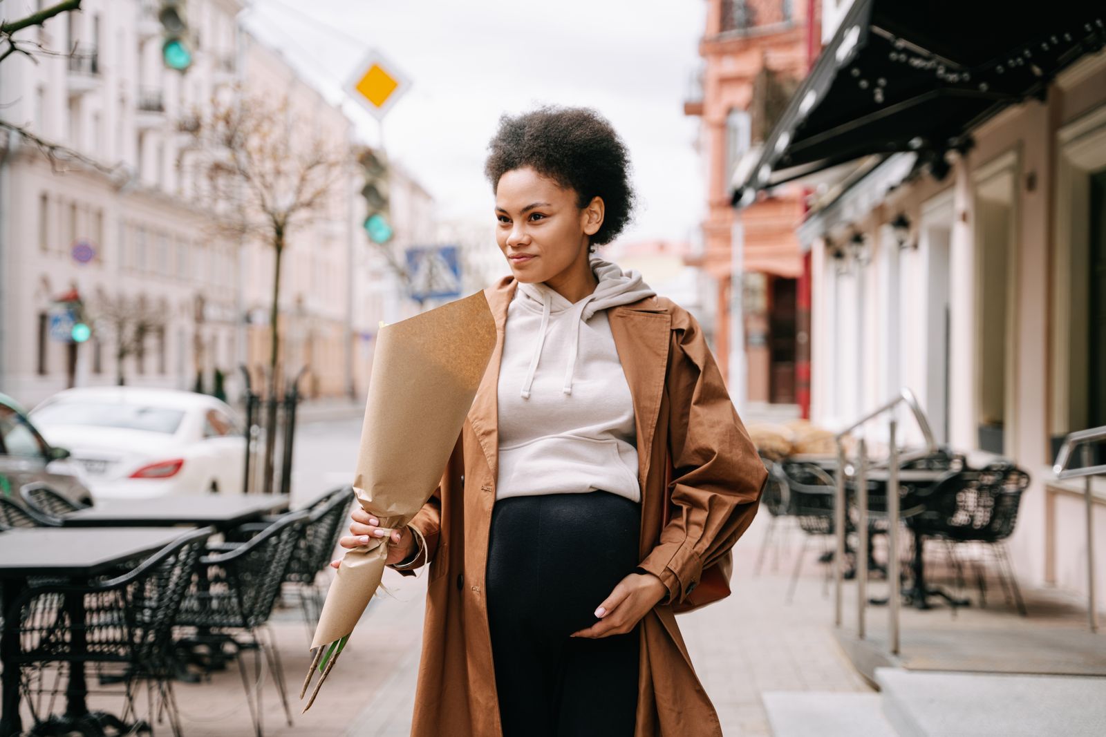 A pregnant woman walking through a city street