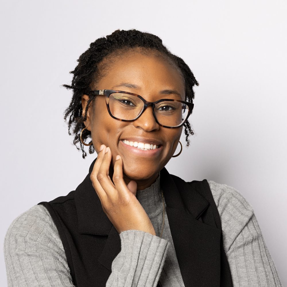 Tiirini Hill, PMHNP-BC, smiling with her hand resting on her cheek